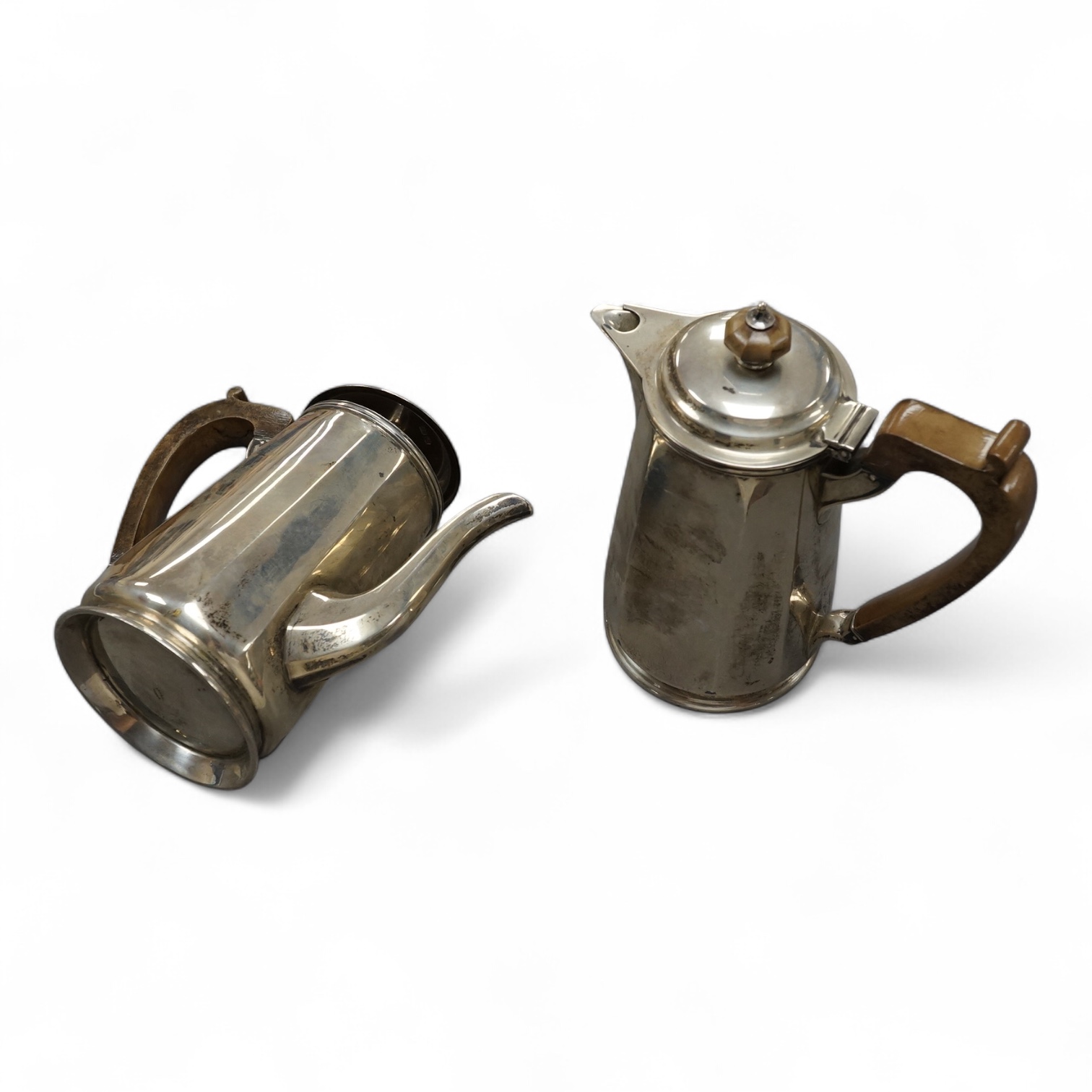 A matched George V silver cafe au lait pair, by Asprey & Co Ltd, London, 1934 and George Howson, Sheffield, 1934, 16.7cm, gross 25.9oz. Condition - fair to good